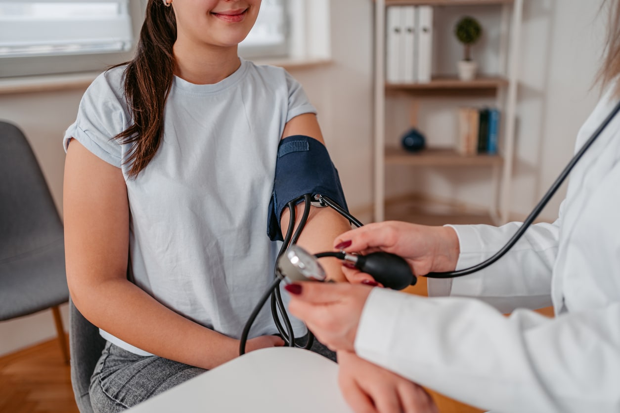 Doctor Measuring Blood Pressure Of A Young Patient